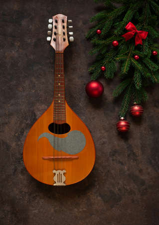 Old mandolin and fir-tree branches with Christmas decor. Christmas and New Year's concept. Top view,...