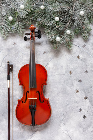 Old violin and fir-tree branches with Christmas decor. Christmas, New Year's concept. top view, close-upの写真素材