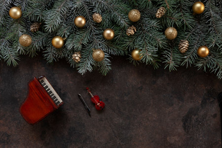 Miniature copies of the piano and violin with golden colored Christmas decor. Christmas, New Year's concept. top view, close-upの写真素材