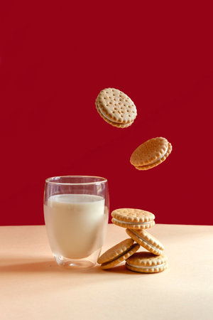 Glass of milk and flying round homemade cookiesの写真素材