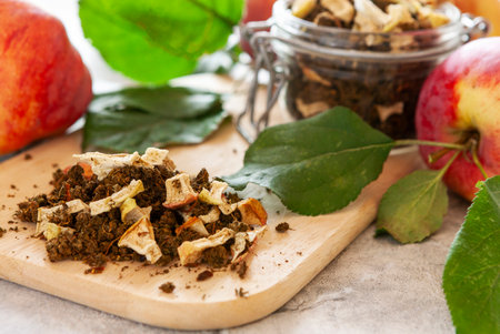 Homemade fermented tea made from fresh apple leaves with dried apple piecesの写真素材