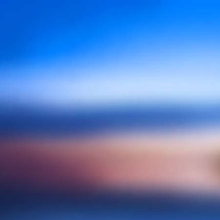 Abstract background in blue and purple colors. Blurred image of ocean shore, blue sky with clouds....