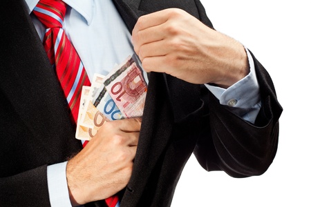 Businessman putting money in his pocket の写真素材