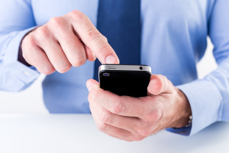 Close up of a businessman hands using smart phone. Shallow depth of field.の写真素材
