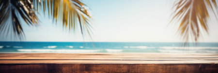 Empty wood table in front of blue sky on summer sea with palm leaf blurred bokeh background concept image for productの素材