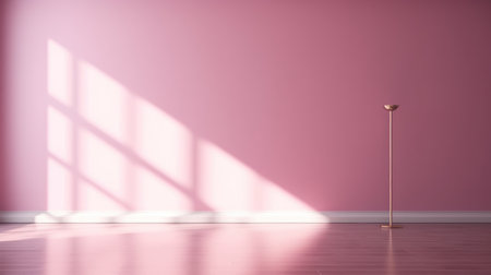 Empty light pink wall with beautiful chiaroscuro. Elegant minimalist background for product presentationの素材
