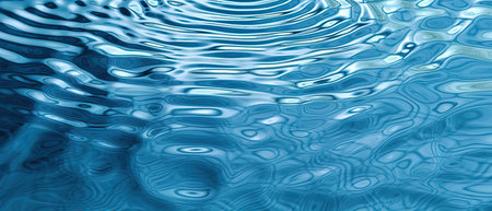 Original light background image of the water surface in shades of blue with a play of light and...