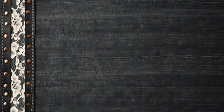 Black denim background with lace borders and small leather label. Dark gray denim jeans fabric texture and vintage lace tape. Copy space for textの素材