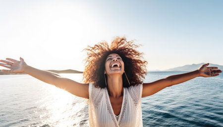 Happy woman with arms outstretched enjoying freedom at the beach, Joyful female having fun walking outside, Healthy lifestyle, happiness and mental health.の素材