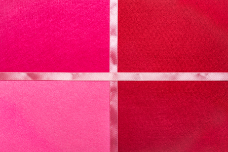 Bright red felt background with satin ribbon.の写真素材