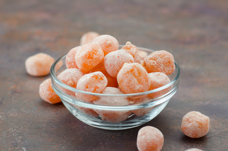 Dried kumquat in a glass bowl on a dark background.の写真素材