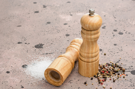 Wooden salt and pepper shaker. Seasoning salt and pepper on the table.の写真素材