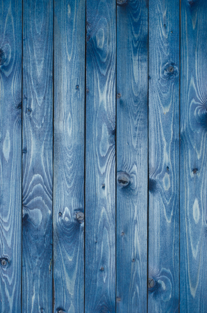 Dark blue wooden background made of a narrow board, painted in dark blue.の写真素材