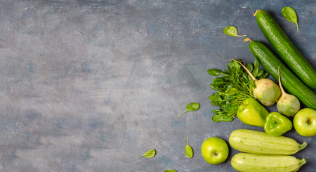 The layout of green vegetables on a dark background. Set for monochrome vegan green salad.の写真素材