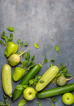 The layout of green vegetables on a dark background. Set for monochrome vegan green salad.の写真素材