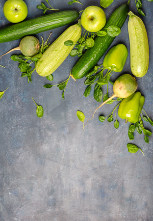 The layout of green vegetables on a dark background. Set for monochrome vegan green salad.の写真素材