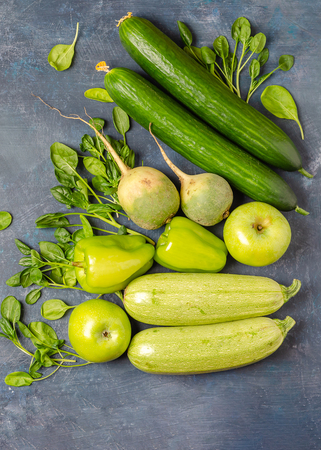 The layout of green vegetables on a dark background. Set for monochrome vegan green salad.の写真素材