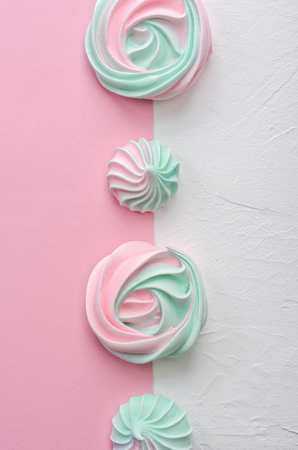Pink turquoise meringue on a pink background. Tea party.の写真素材