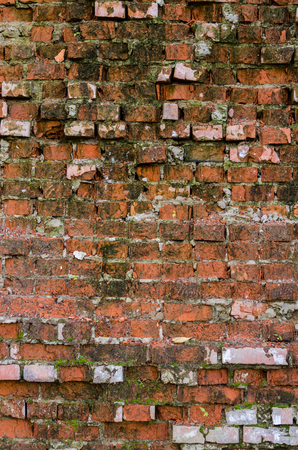 Red brick background. Old, ruined street wall.の写真素材