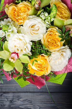 A bouquet of flowers on a dark wooden background. Bouquet with roses.の写真素材