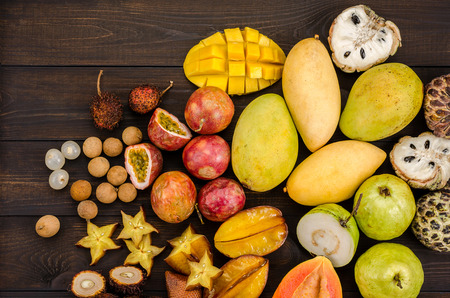 Assorted Thai tropical fruits on a dark wooden rustic background.の写真素材