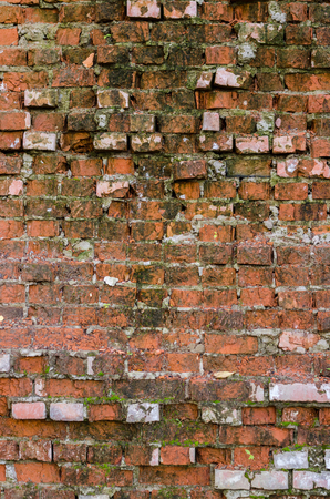 Red brick background. Old, ruined street wall.の写真素材