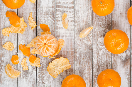 Peele dripe tangerines on wooden light backgroundの写真素材