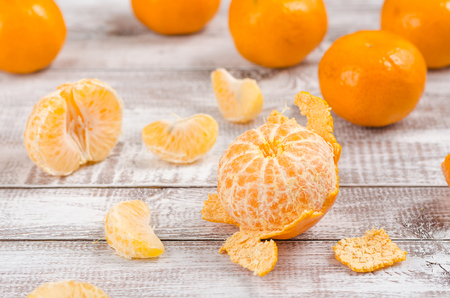 Peele dripe tangerines on wooden light backgroundの写真素材