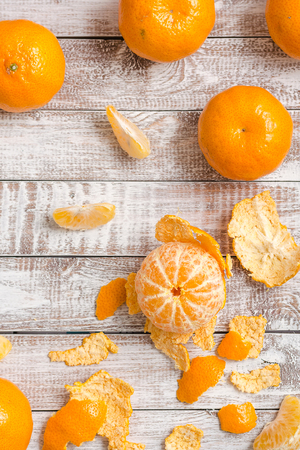 Peele dripe tangerines on wooden light backgroundの写真素材