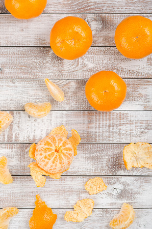 Peele dripe tangerines on wooden light backgroundの写真素材