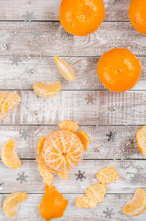 Peele dripe tangerines on wooden light backgroundの写真素材