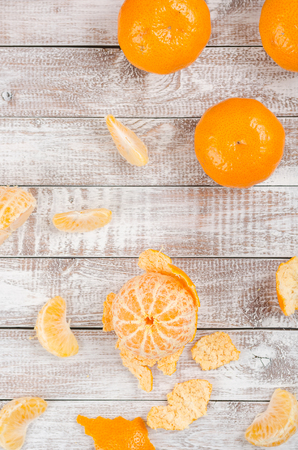 Peele dripe tangerines on wooden light backgroundの写真素材