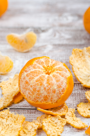 Peele dripe tangerines on wooden light backgroundの写真素材