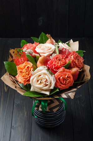 Bouquet of flowers with pears on a dark wooden background. Fruit bouquet.の写真素材