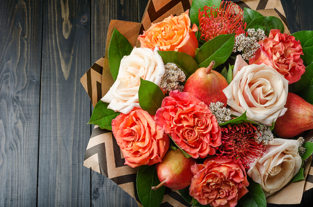 Bouquet of flowers with pears on a dark wooden background. Fruit bouquet.の写真素材