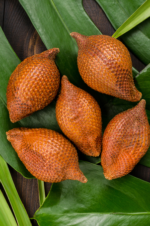 Snake fruit, rakum, sala on wood background. Tropical fruit.の写真素材
