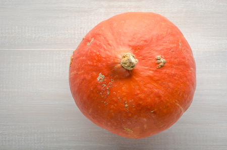 Orange pumpkin on a light wooden background.の写真素材