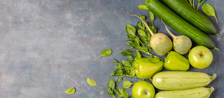 The layout of green vegetables on a dark background. Set for monochrome vegan green salad.の写真素材