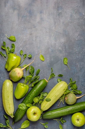 The layout of green vegetables on a dark background. Set for monochrome vegan green salad.の写真素材