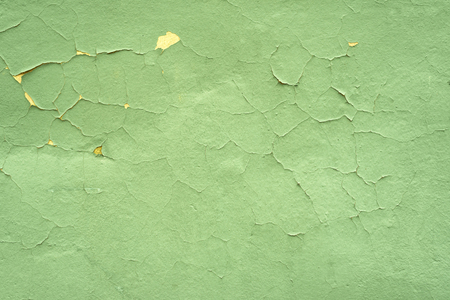 Warm green shabby textural background. Cracked paint wall.の写真素材