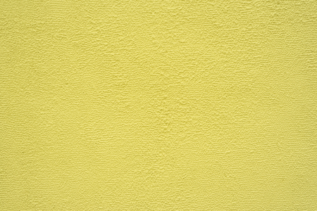 Bright yellow fine texture of plaster. Background.の写真素材