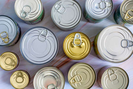 Overhead view various closed tin cans with food preserves. Canned food in different sizes and colors. Stock non-perishable preserved foodの写真素材