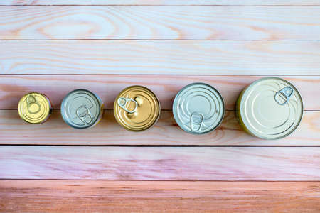 Overhead view row canned food in different sizes and colors. Stock preserved foodの写真素材