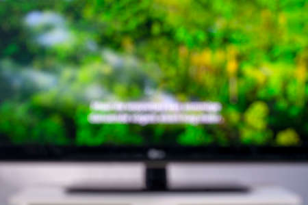 Blurred image of a television screen with a nature documentary and subtitlesの写真素材