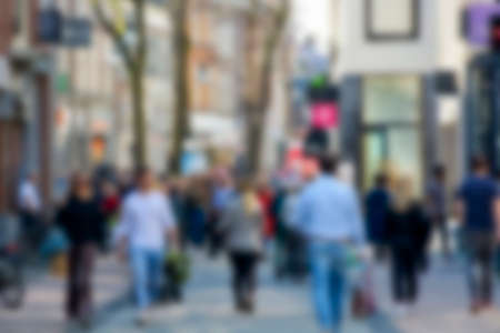 Blurred image of unrecognizable crowd of people shopping in the city streetの写真素材