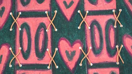 original design of heart, naughts and crosses, oil pastels and string