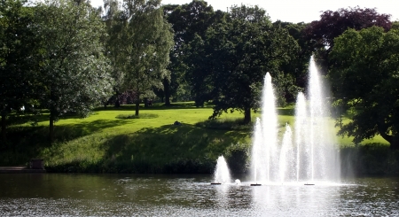 fountains in the lake, late afternoon in the parkの写真素材