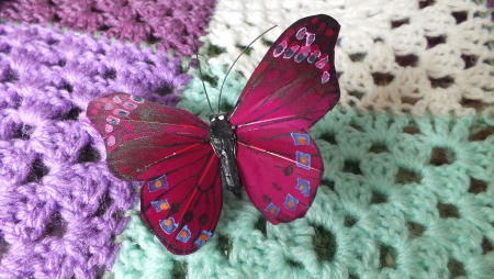 shabby chic feather butterfly on crochet blanket の写真素材