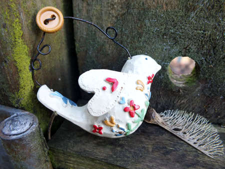 Decorative shabby chic bird with old wood grunge background and decayed sycamore seed の写真素材