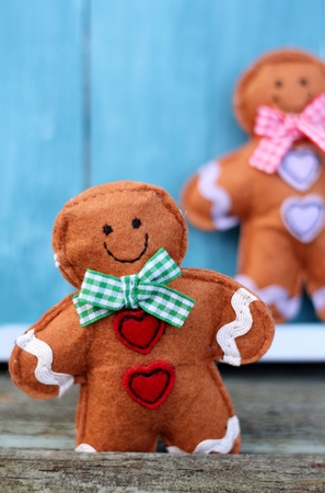 Shabby Chic felt Ginger Bread man on a weathered old wooden bench  の写真素材
